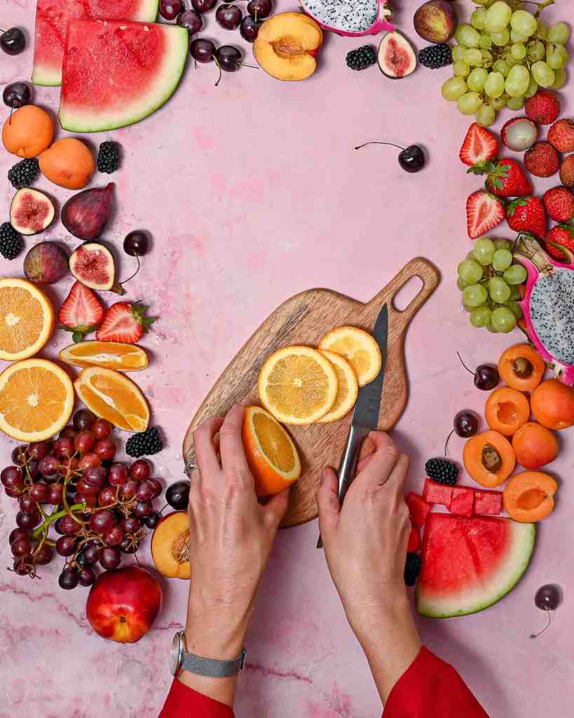 Abundant fresh fruit spread on pink marbled backdrop-Brisbane food photographer